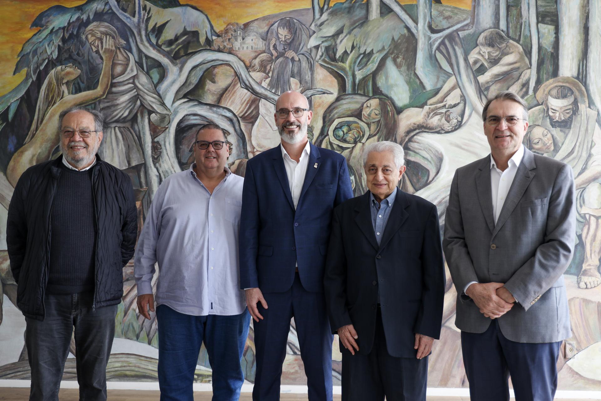Fotografia colorida horizontal com cinco homens alinhados lado a lado
